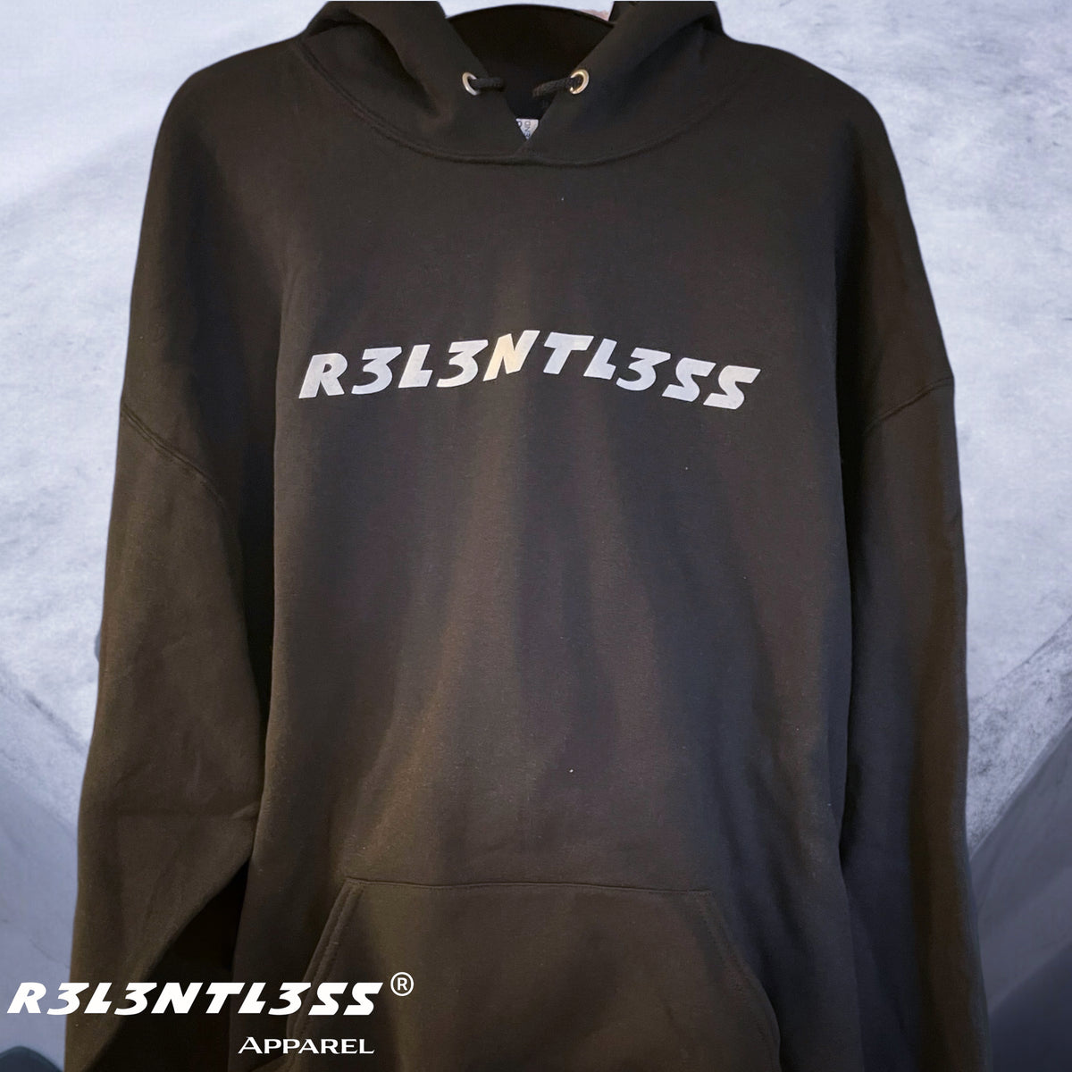 A black hoodie with the text &#39;R3L3NTL3SS&#39; printed across the front, featuring a hood, pouch pocket, and the brand&#39;s logo.