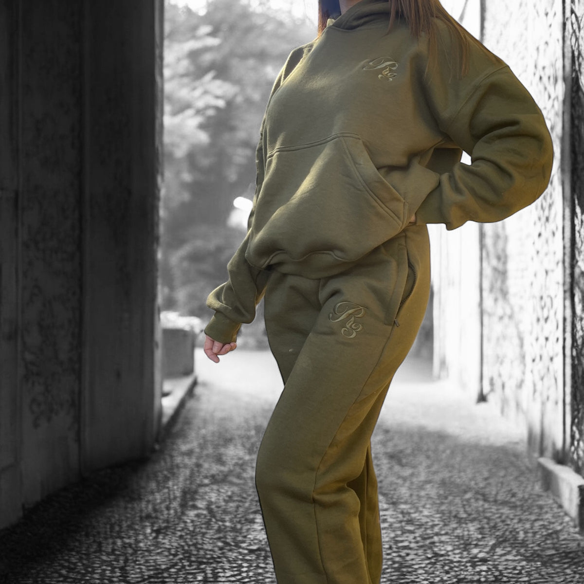 A person wearing a gray Coz3 Max Hoodie with the hood up, standing in a snowy outdoor setting.